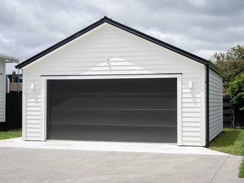 Double detached white garage with black tilt-up retractable rais